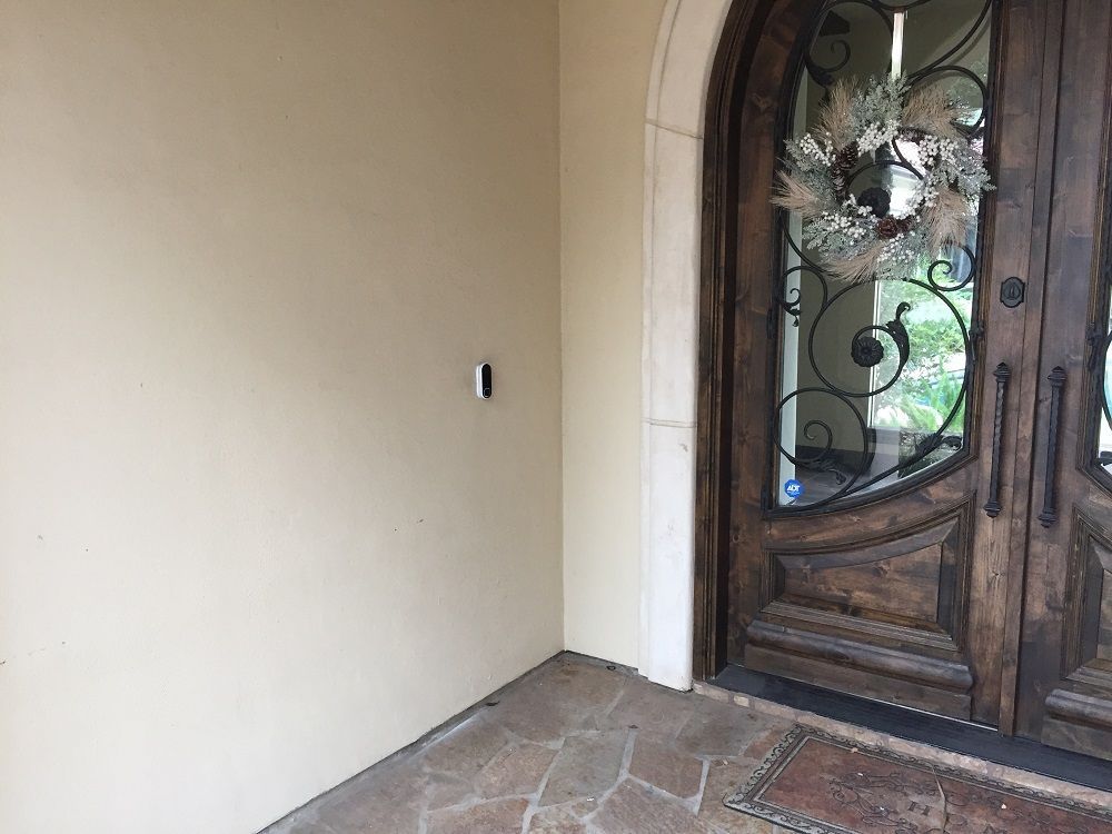 The front door of a house with a wreath on it.