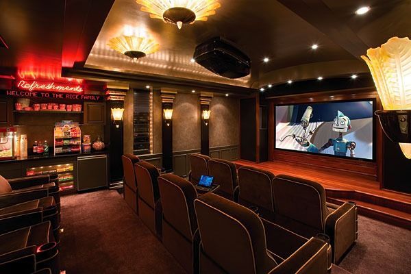 A home theater with a large screen and lots of seats
