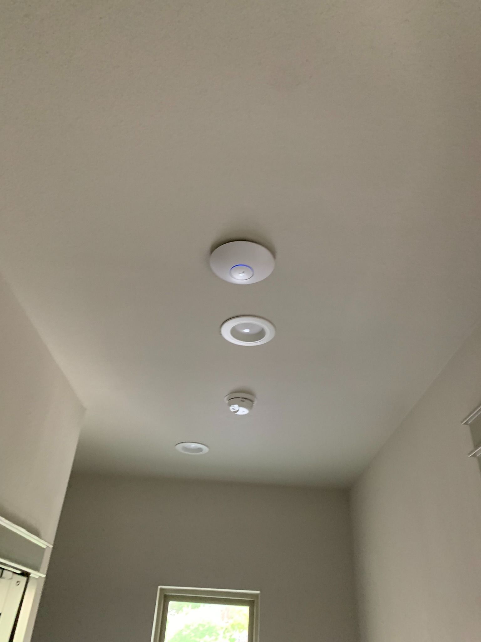 There are three lights hanging from the ceiling of a room.