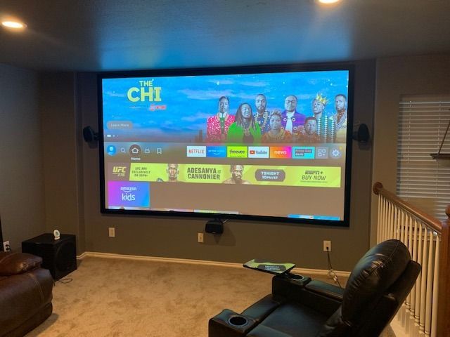 A living room with a projector screen that says the chi on it