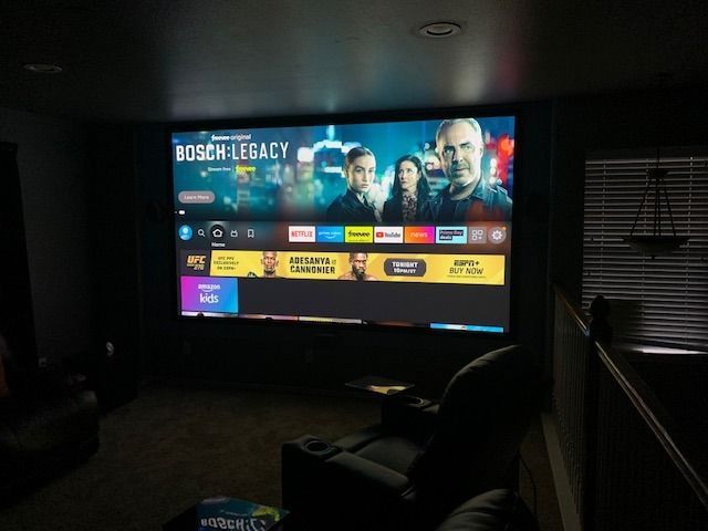 A projector screen shows a movie called bosch legacy