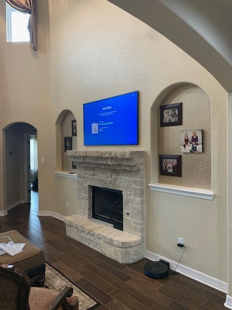 A living room with a fireplace and a flat screen tv