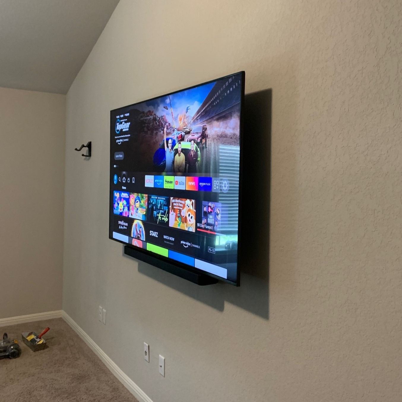 A large flat screen tv is mounted on a wall