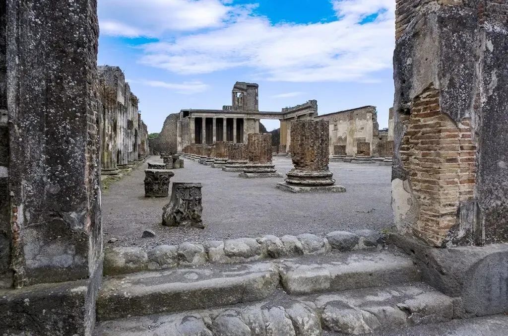 Ancient stone ruins with columns and steps under a blue sky