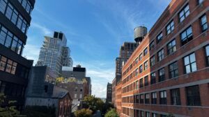 City street with modern brick and glass buildings under a clear sky