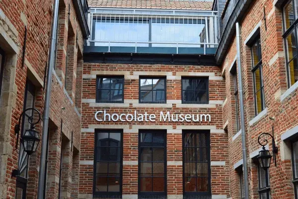 Brick courtyard exterior with a “Chocolate Museum” sign on a red-brick building.