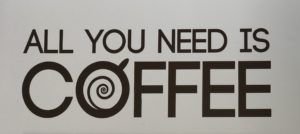 “All you need is coffee” text in black on a light background, with a coffee cup logo in the O.