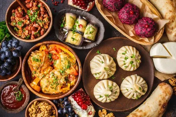 Assorted Indian appetizers and chutneys arranged on a wooden platter with vibrant colors and breads