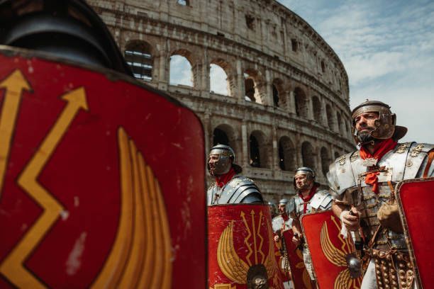 Roman soldiers with red shields in front of the Colosseum