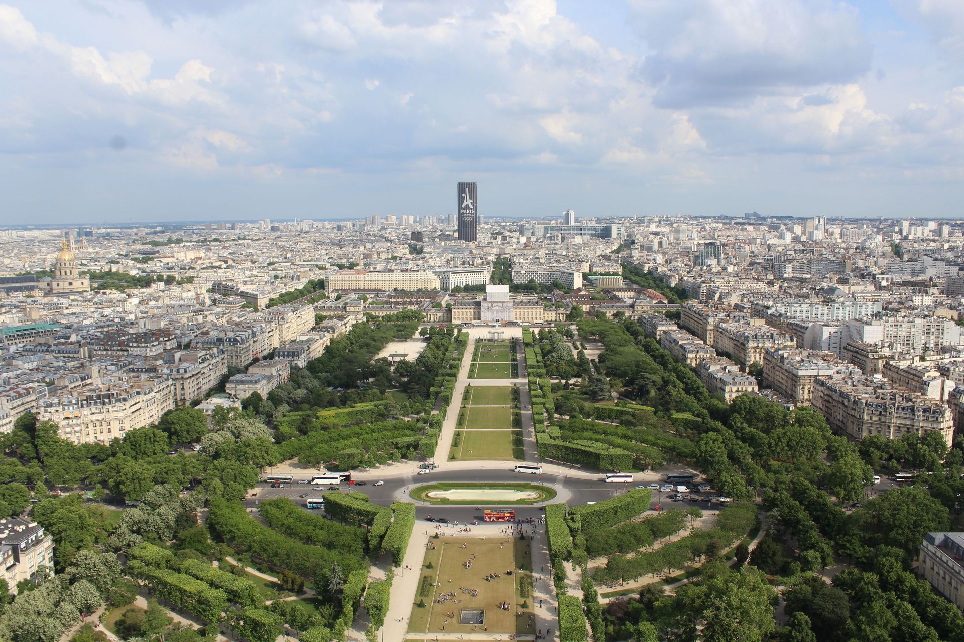 Aerial view of Paris with the Eiffel Tower centered along the Champ de Mars and city skyline stretching beyond