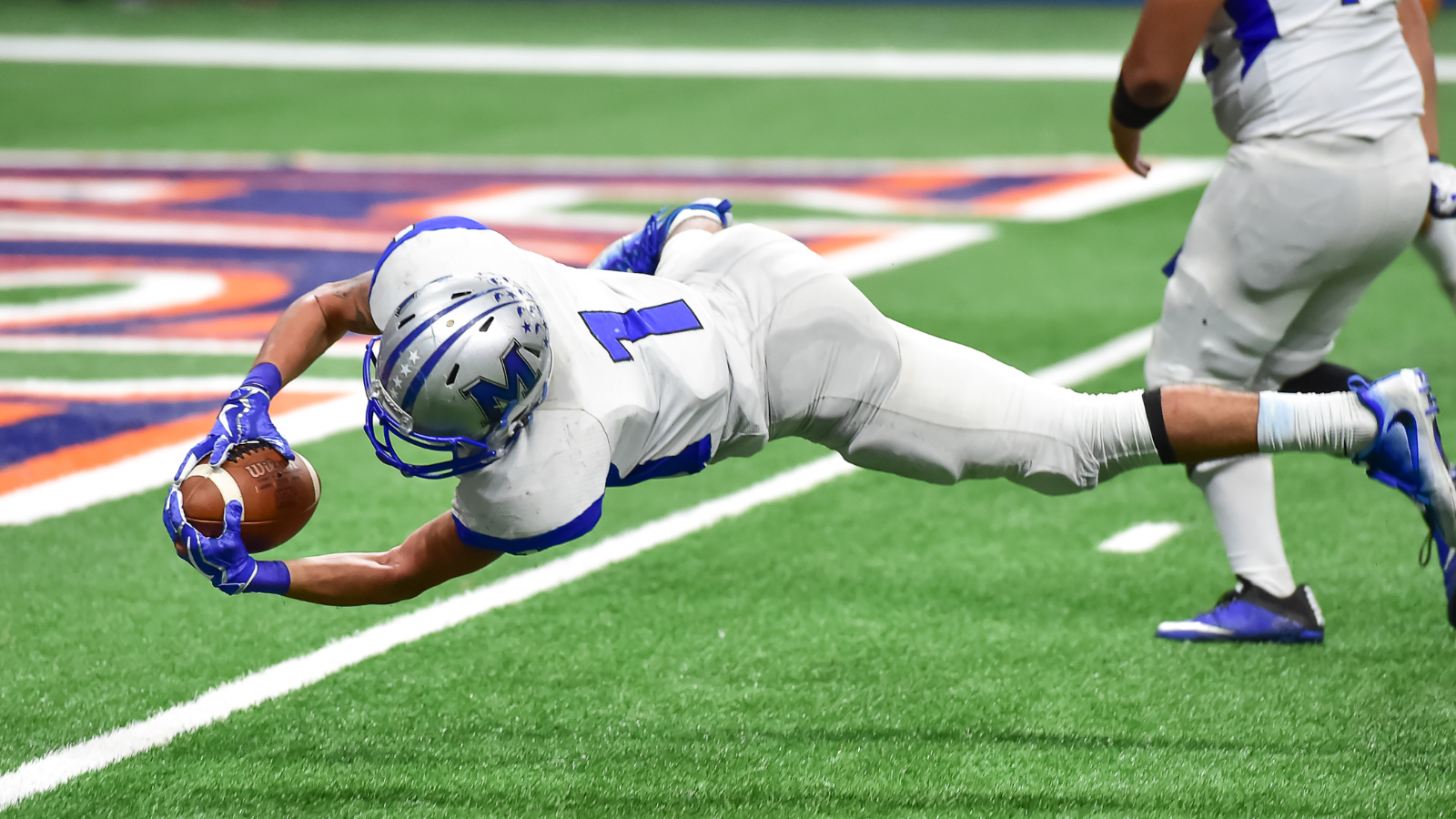 NFL player diving for a touchdown