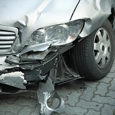 A silver car that has been damaged in an accident