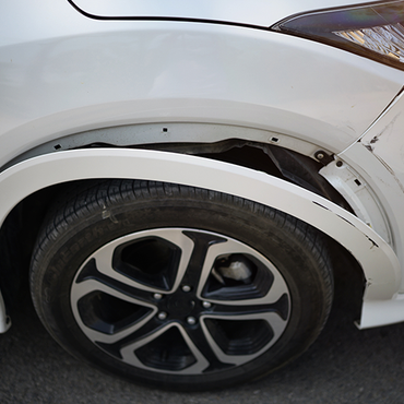 A close up of a wheel on a white car