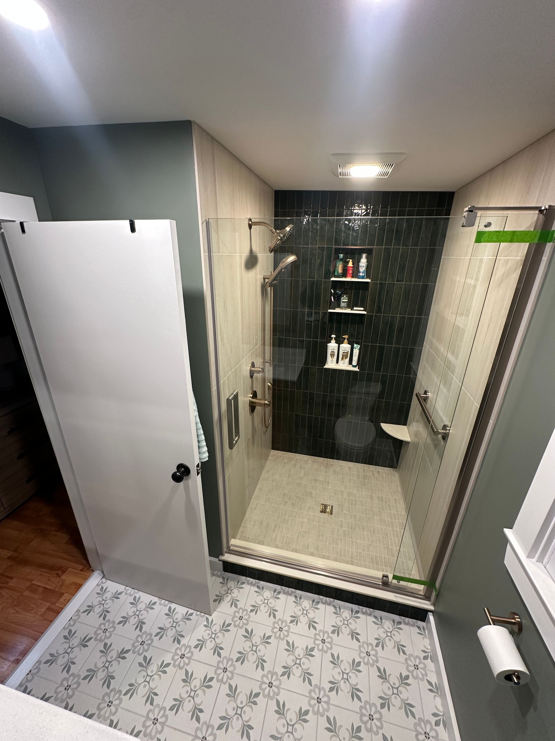 A bathroom with a walk in shower and a toilet.