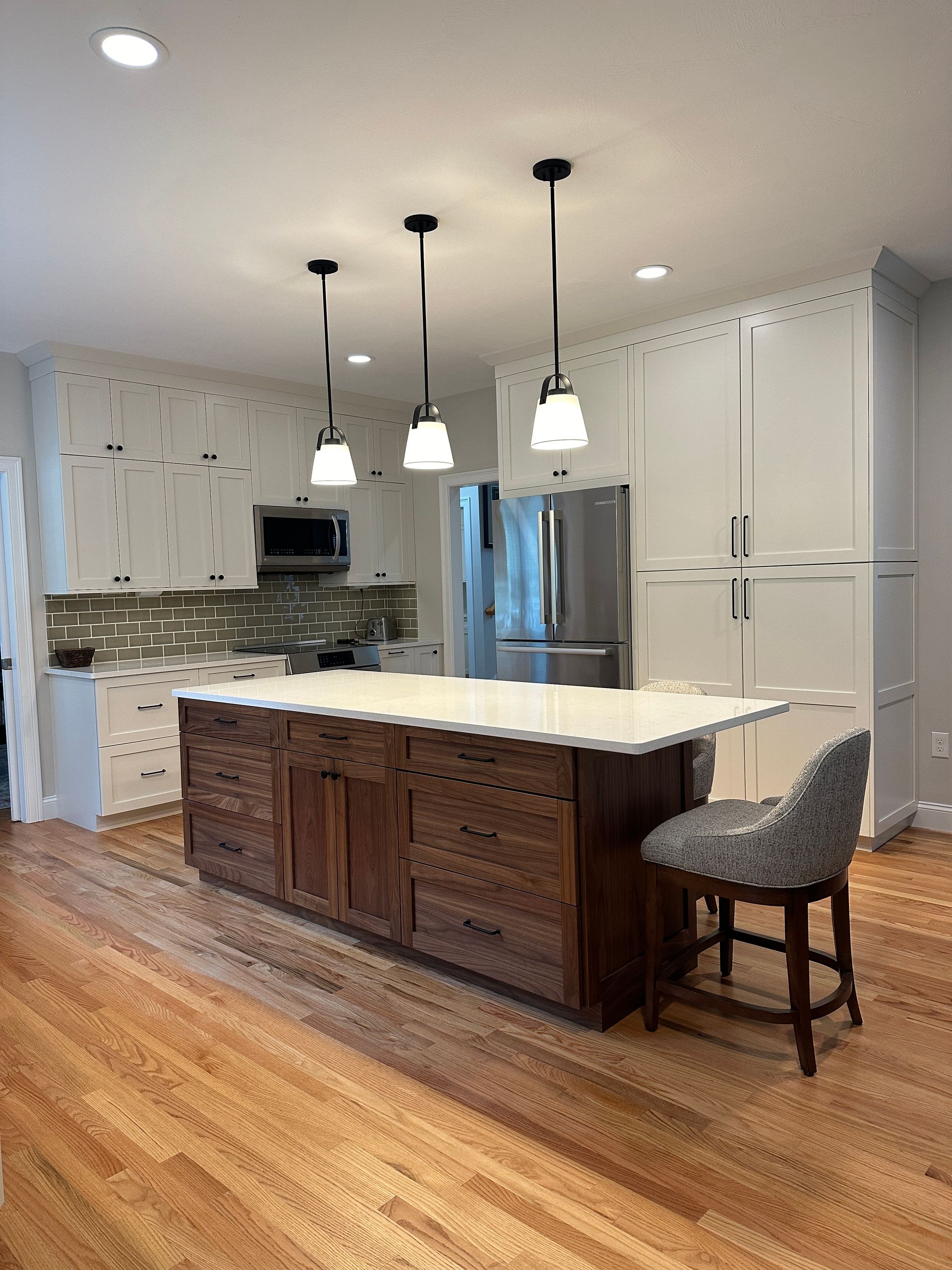 There is a large island in the middle of the kitchen.