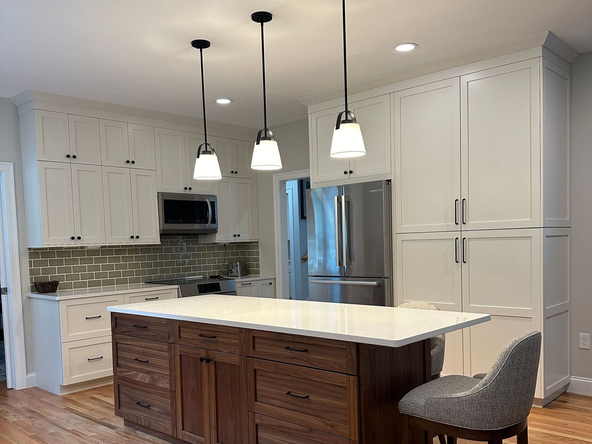 A kitchen under construction with white cabinets and blue counter tops.