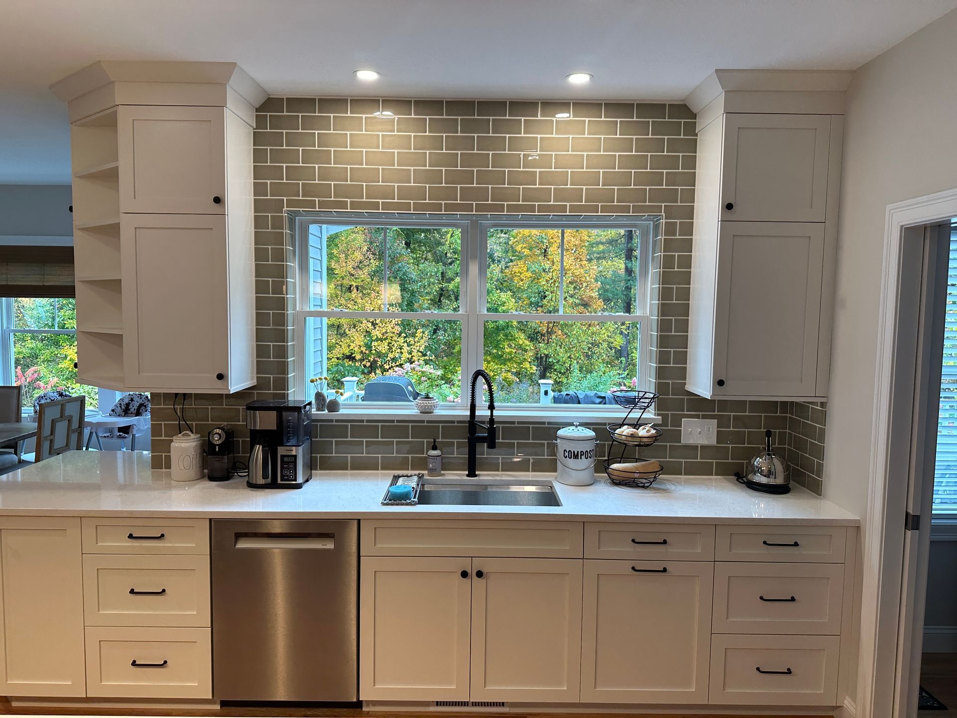 A kitchen with a large island and stools in a house.