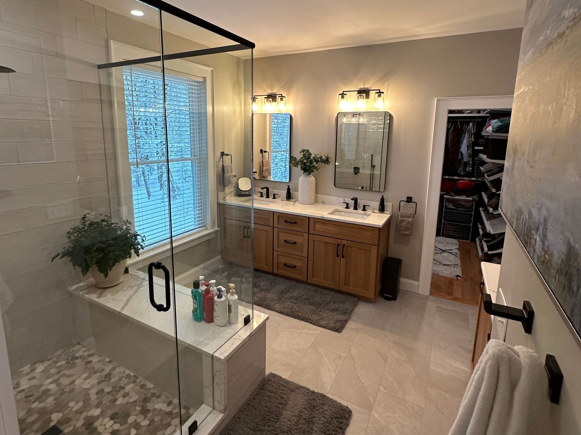 A bathroom with a walk in shower and a bathtub.