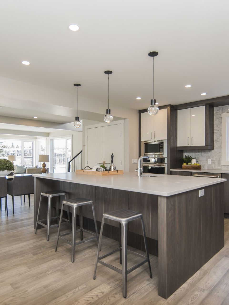 A kitchen with a large island and stools