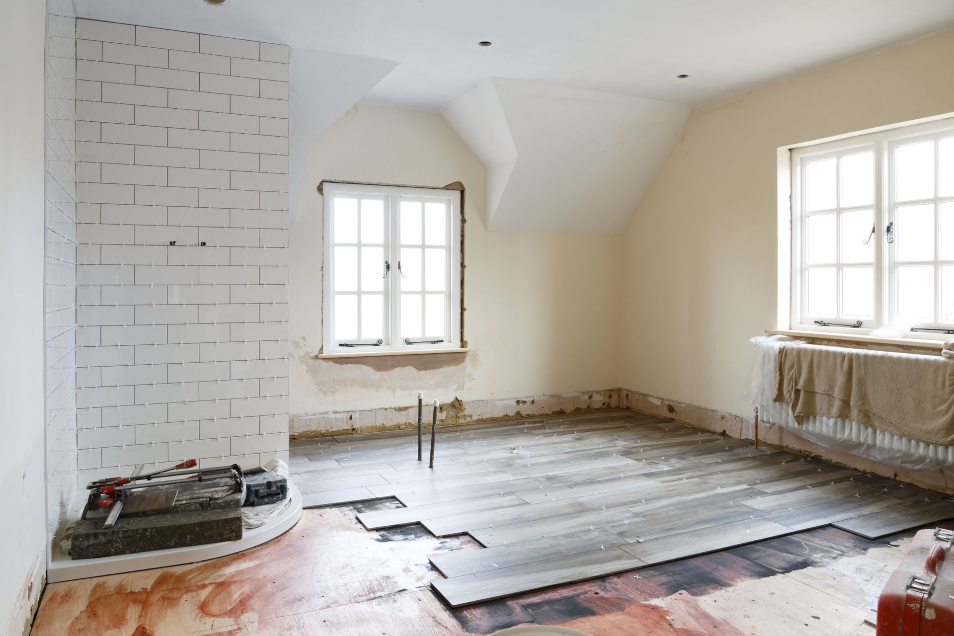 An empty room with a wooden floor and a window