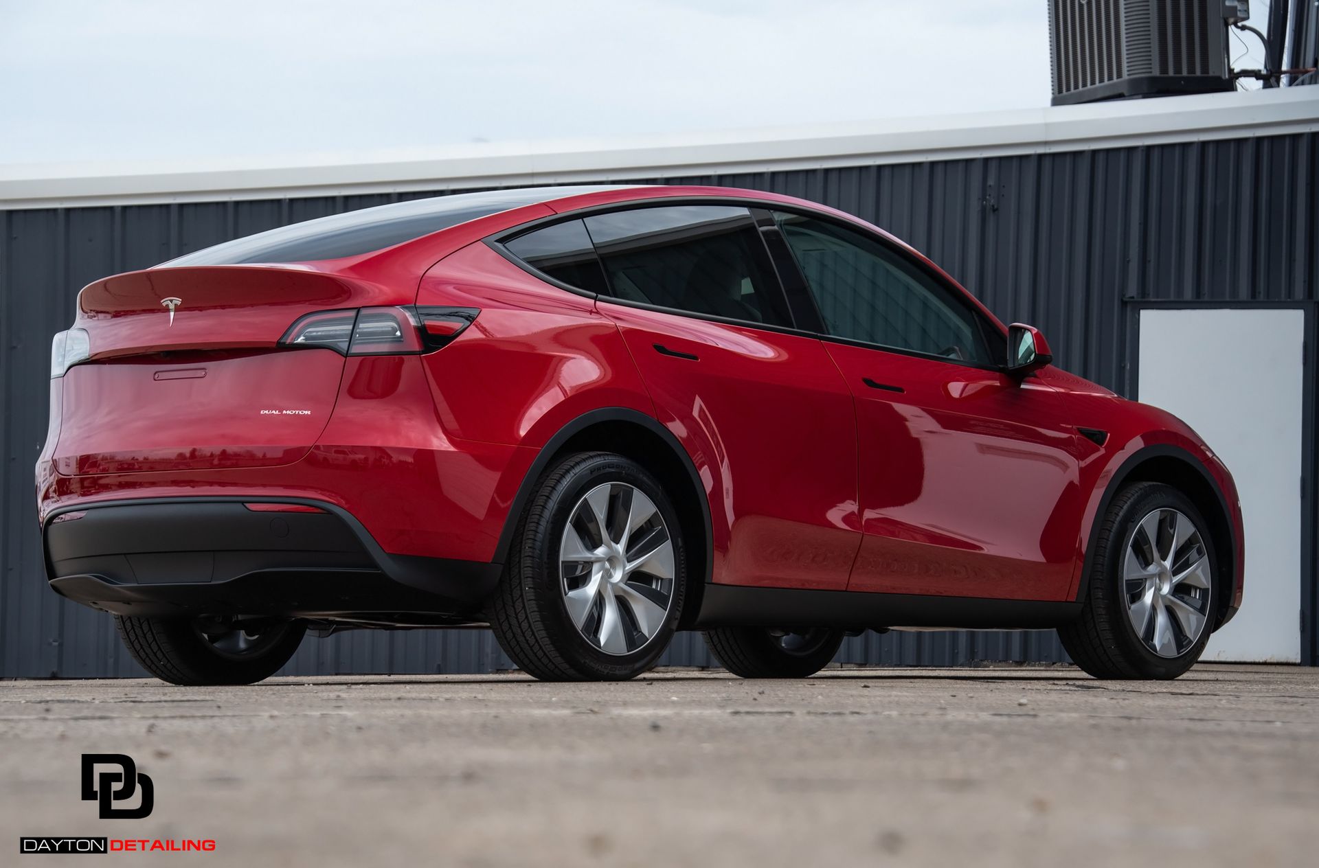 back view of a ceramic-coated red Tesla vehicle