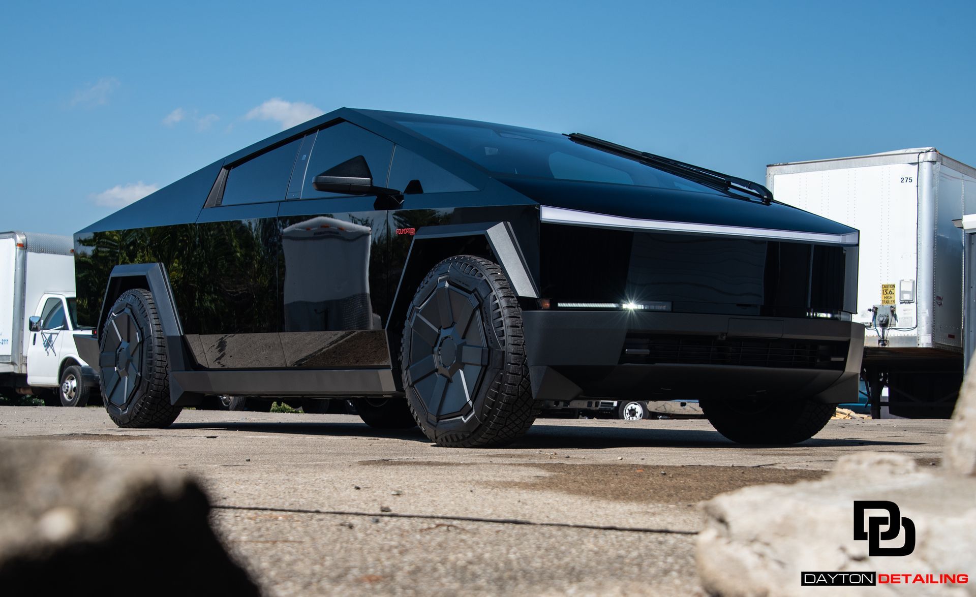 A tesla cybertruck is parked in a parking lot.