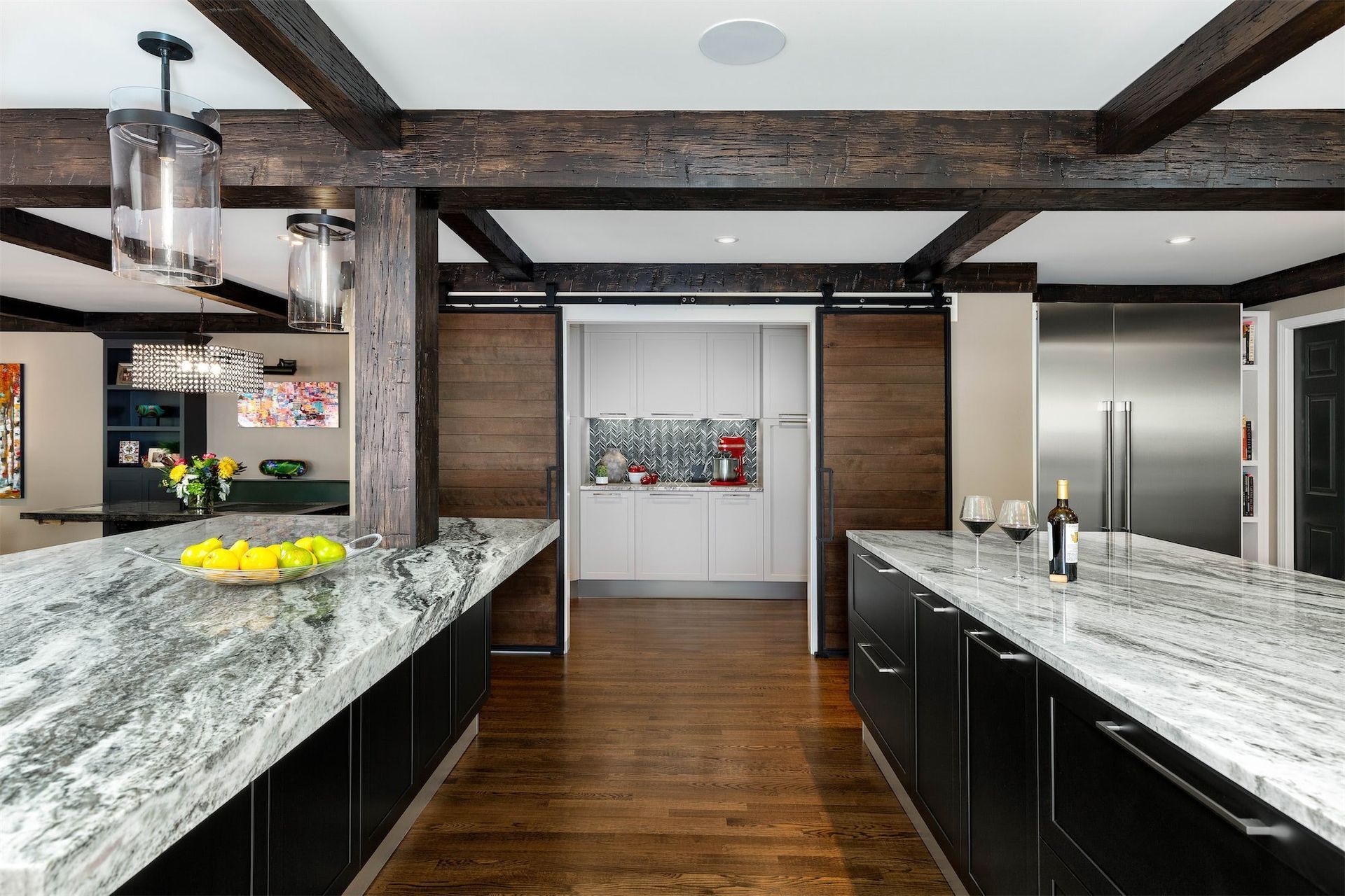 A kitchen with granite counter tops and stainless steel appliances.