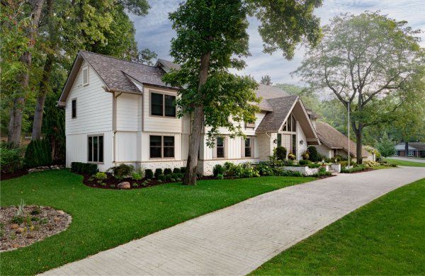 A large white house with a driveway leading to it