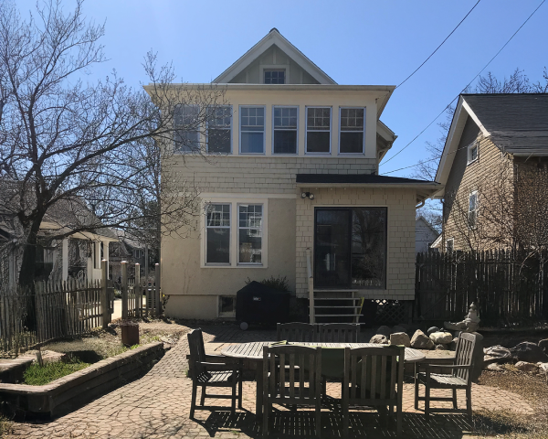 A house with a table and chairs in front of it