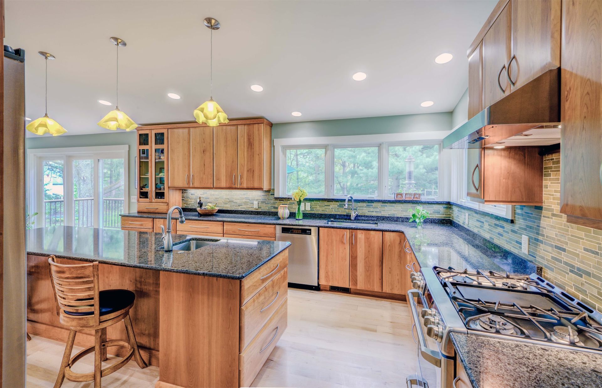A kitchen with granite counter tops and wooden cabinets