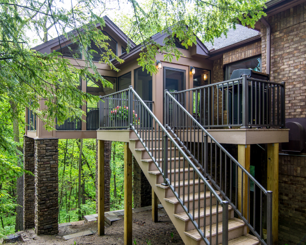 A house with a deck and stairs leading up to it
