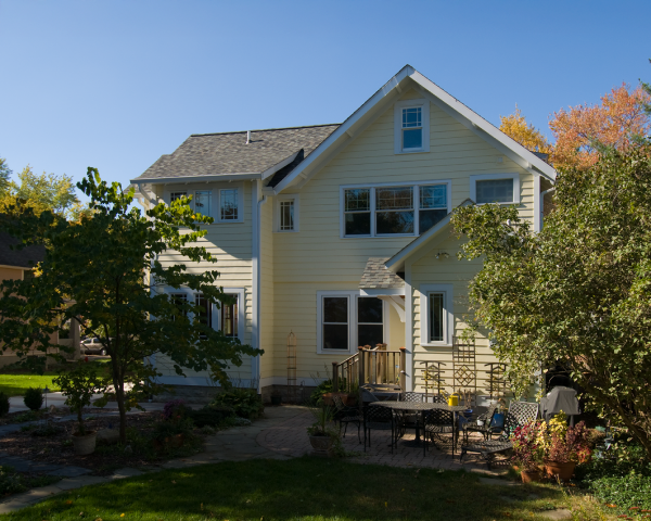 A large white house with a patio in front of it
