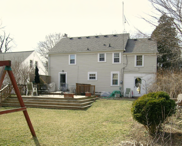 A house with a swing set in front of it
