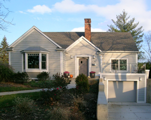 A small white house with a brick chimney