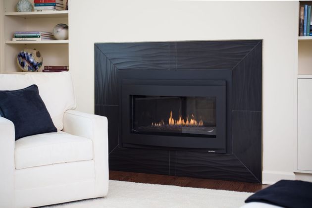 A living room with a fireplace and a chair