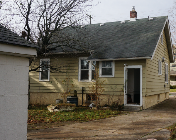 A small house with a chimney on the roof