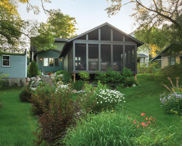 A house with a screened in porch in the backyard