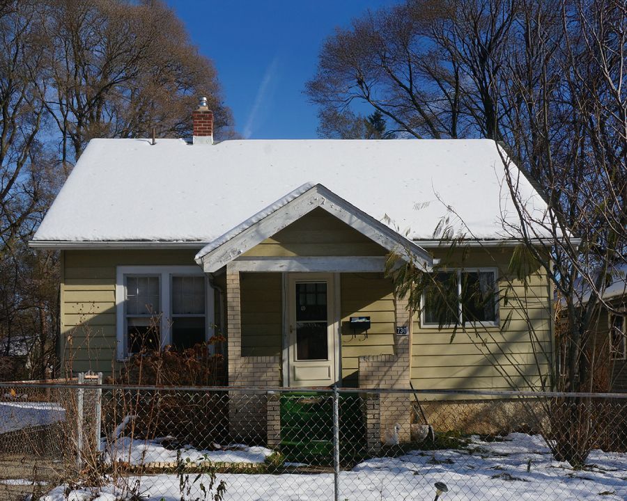 A small house with snow on the roof