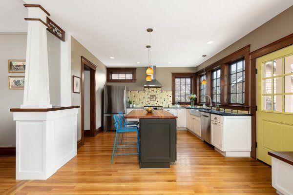 A kitchen with a large island and a yellow door