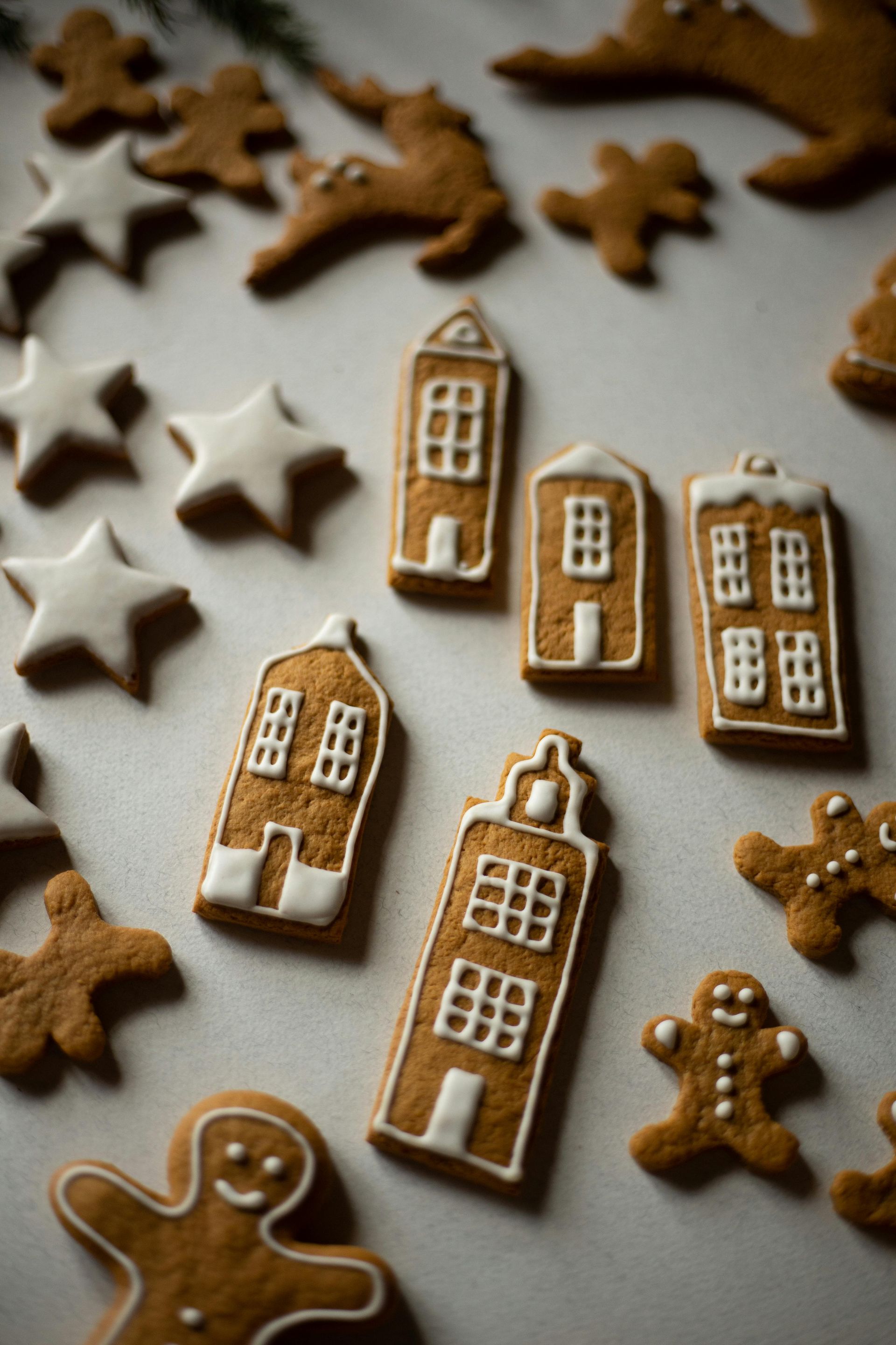 There are many different gingerbread cookies on the table.