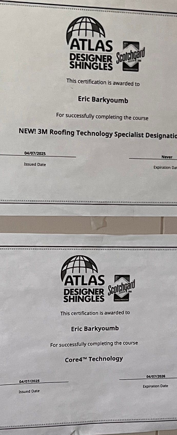 Blurry photo of two Atlas Shingles document pages stacked vertically on a light background