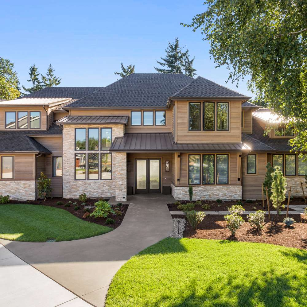 A large house with a lot of windows and a driveway