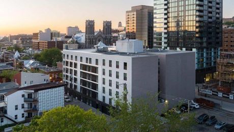 Une vue aérienne d'un grand bâtiment agricole avec un toit vert