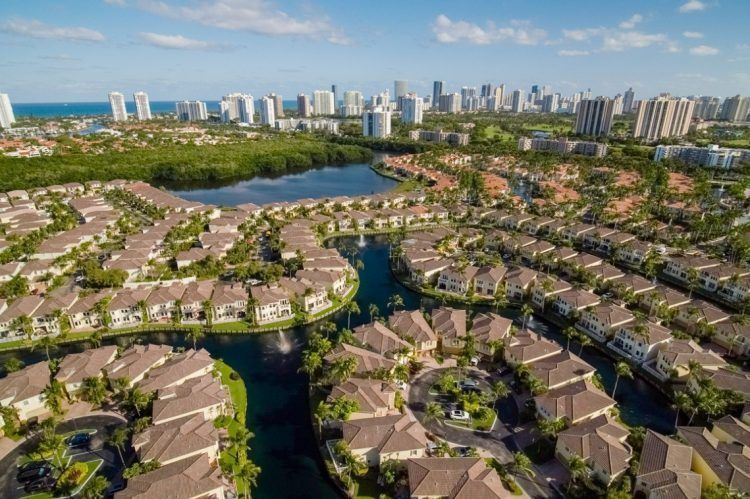 An aerial view of a residential area with a city in the background.
