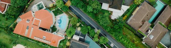 An aerial view of a residential area with houses and a road.