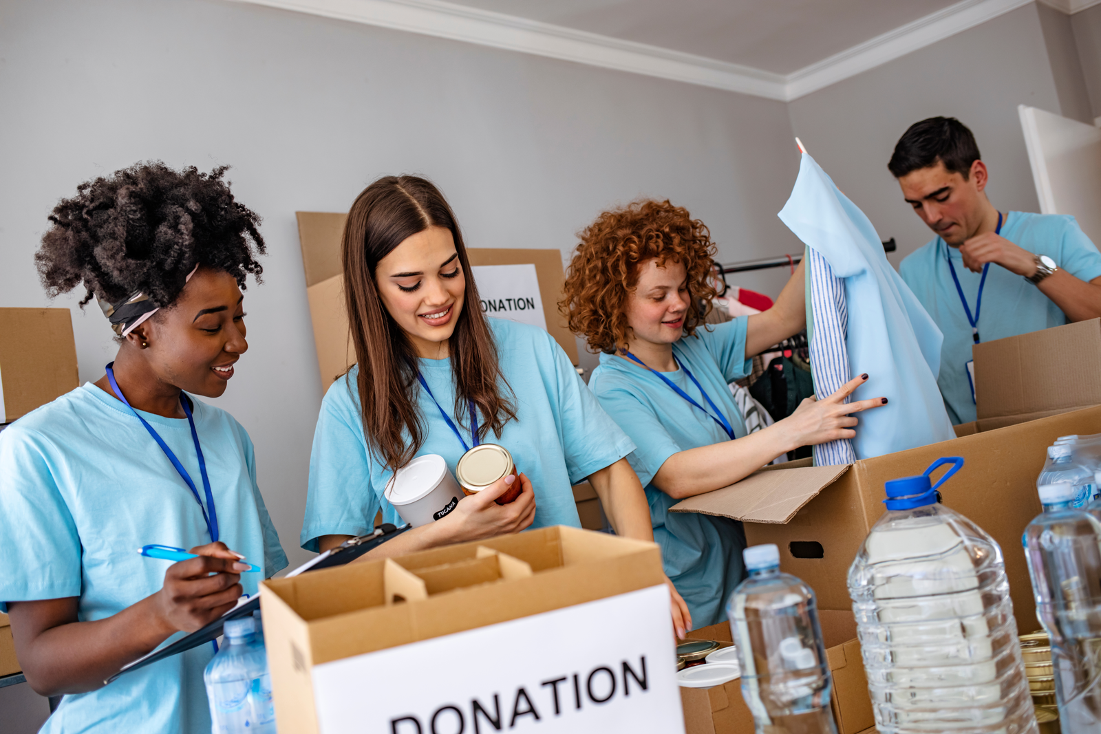 A group of people are packing donations into cardboard boxes.
