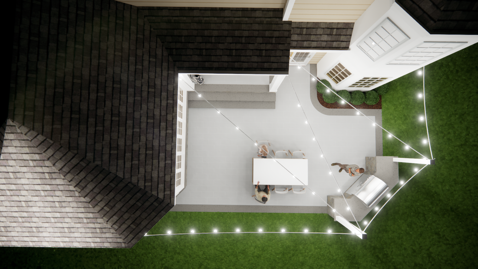 Aerial view of a backyard patio with a table, chairs, string lights, and a house roof edge.