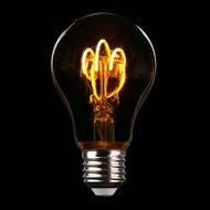Glowing vintage light bulb with visible orange filament on a black background