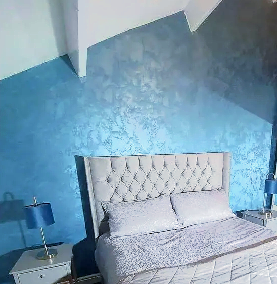 A general interior view of a grey coloured double bedroom within an apartment
