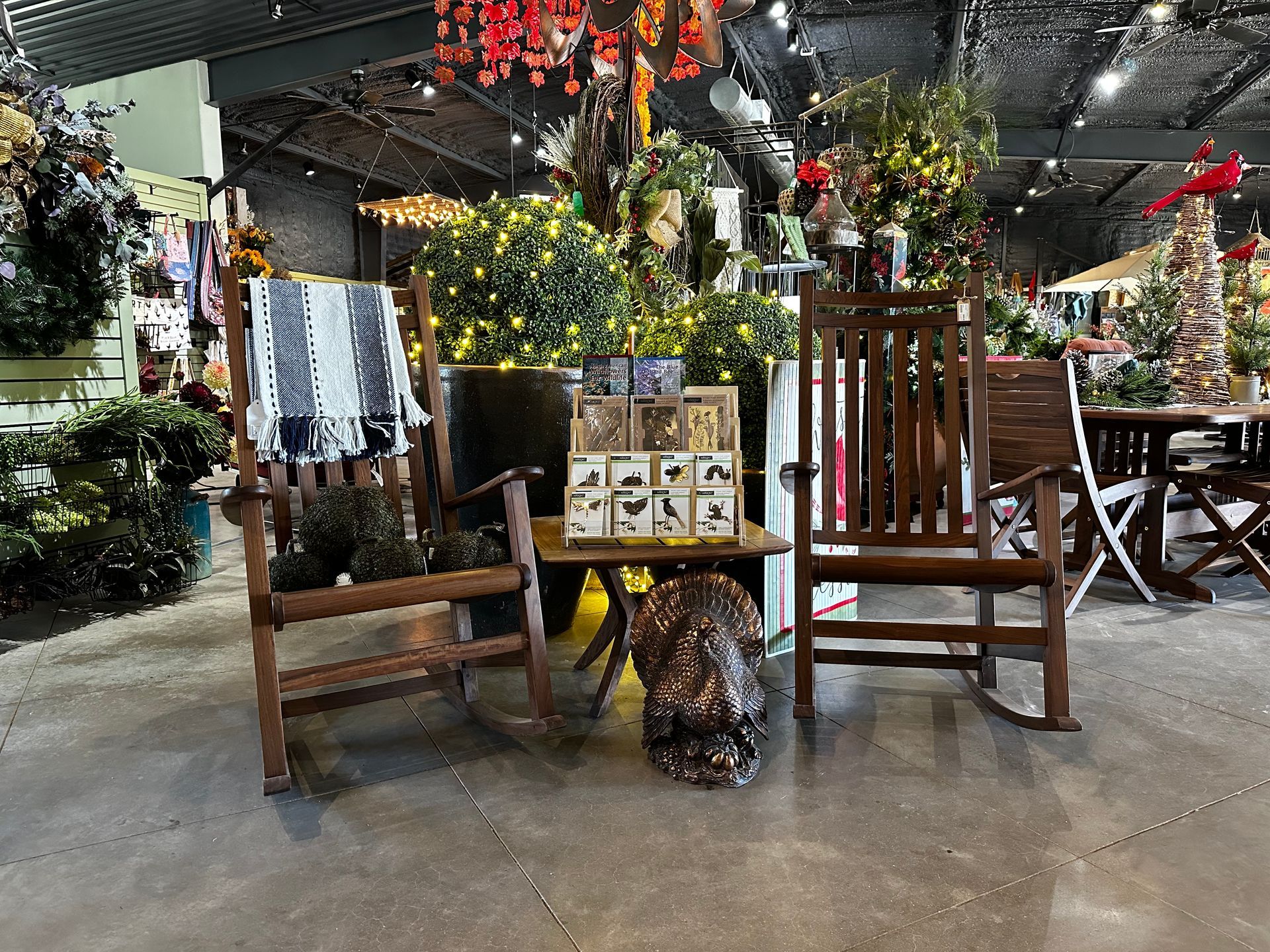 Two wooden rocking chairs are sitting next to a table in a room.